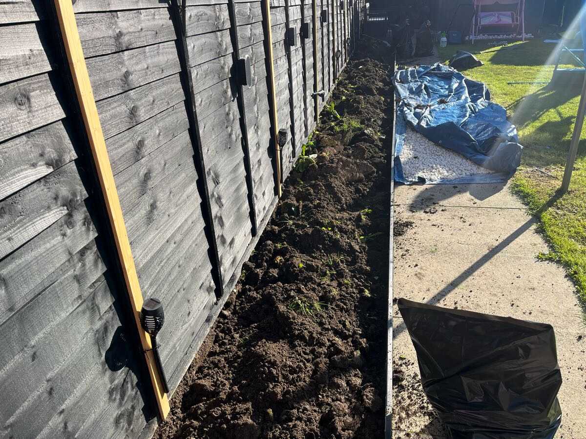 Before — Tired border dug out and finished with a new decorative stone path