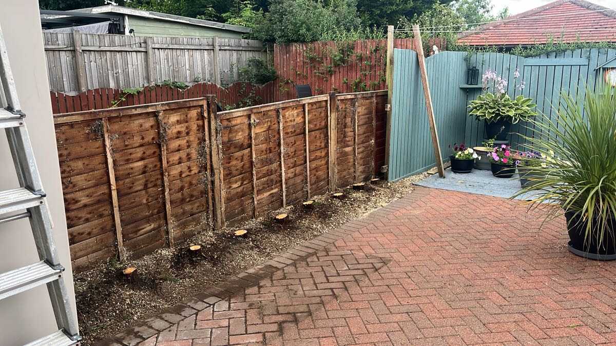 Fence line cleared and border tidied along a monoblock patio in Glasgow